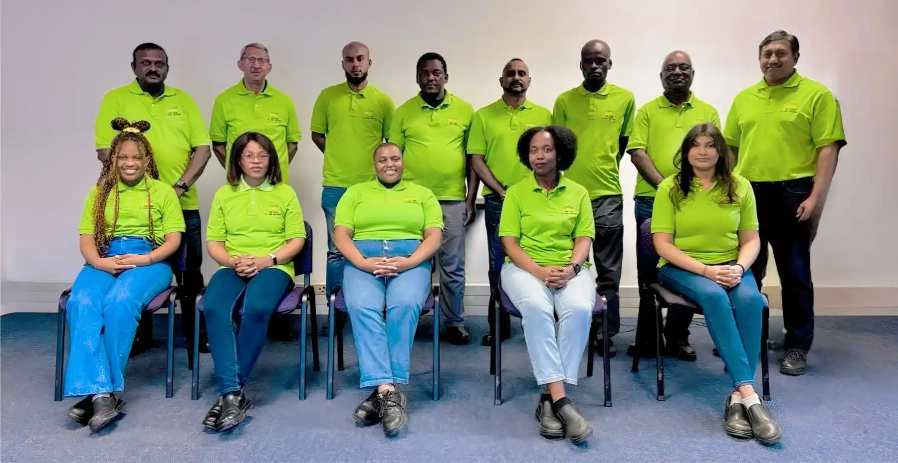 FAS Full team photo. all members wearing green shirts and posing for photo.